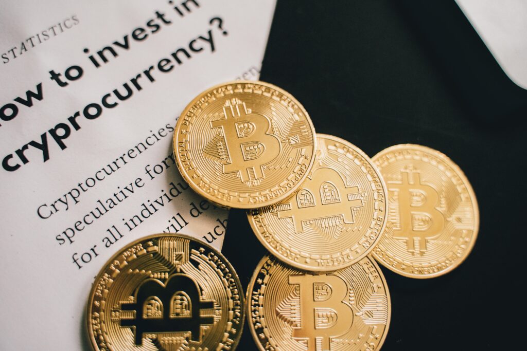 Beginner’s Guide to Cryptocurrency Close-up of Bitcoin coins alongside an investment guide in cryptocurrency.