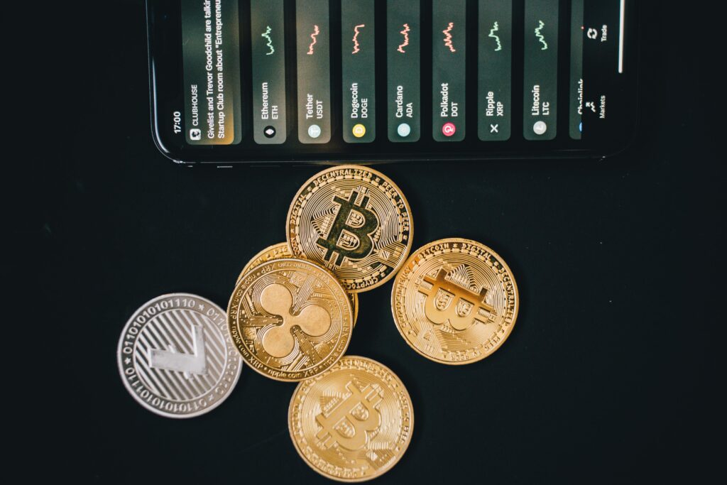 How Partnerships Drive Blockchain Innovation Close-up of various cryptocurrencies and a smartphone showing market trends.
