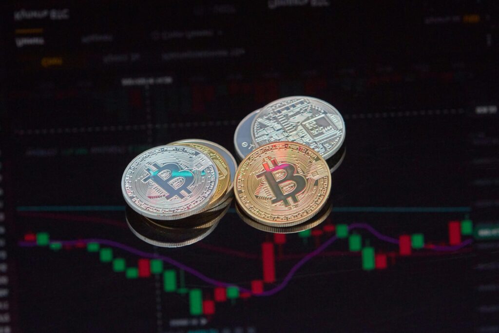 Understanding Cryptocurrency Regulations Close-up view of Bitcoin coins on a stock market chart background representing cryptocurrency trading.