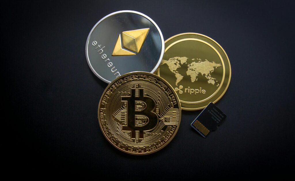 Strategic Partnerships in Crypto Projects A striking image of Bitcoin, Ethereum, and Ripple coins illustrating modern digital currency.
