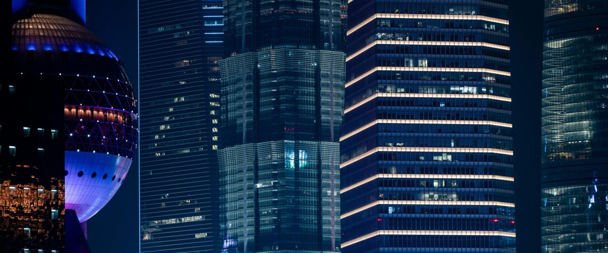 Vibrant night view of Shanghai's modern skyscrapers and the iconic Oriental Pearl Tower.