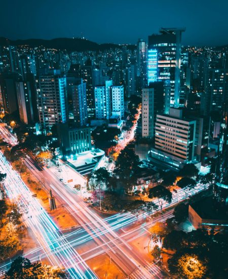 Breathtaking aerial view of Belo Horizonte with vibrant light trails at night, showcasing urban city life.
